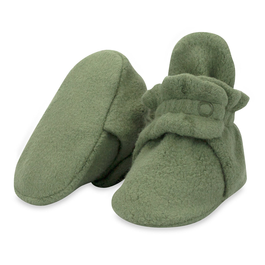 Green baby booties with adjustable snaps on the top.