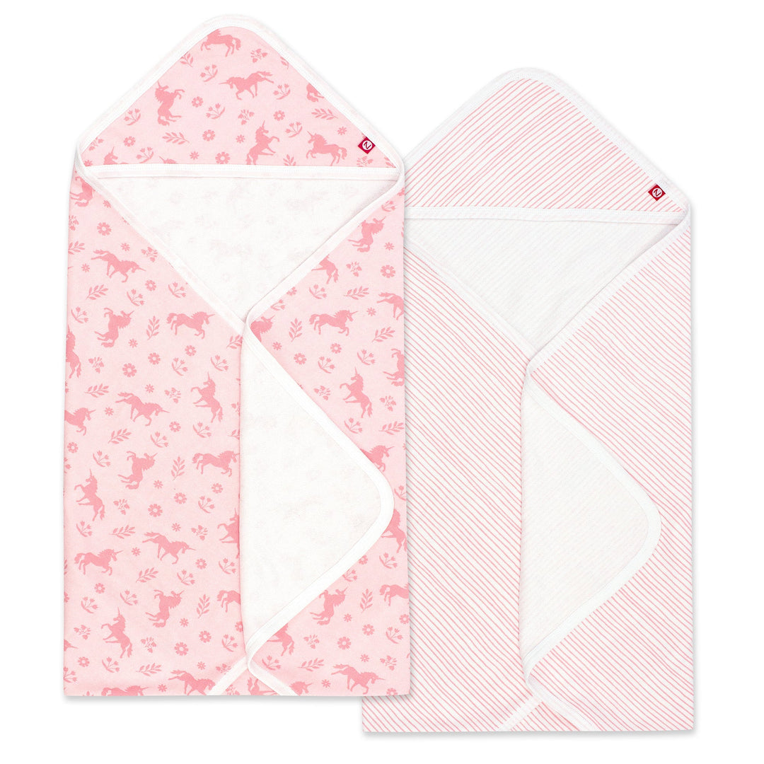 Two pink hooded towels with one featuring a unicorn print and the other a pencil stripe design