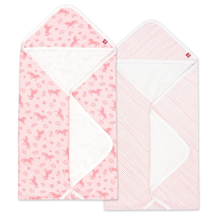 Two pink hooded towels with one featuring a unicorn print and the other a pencil stripe design