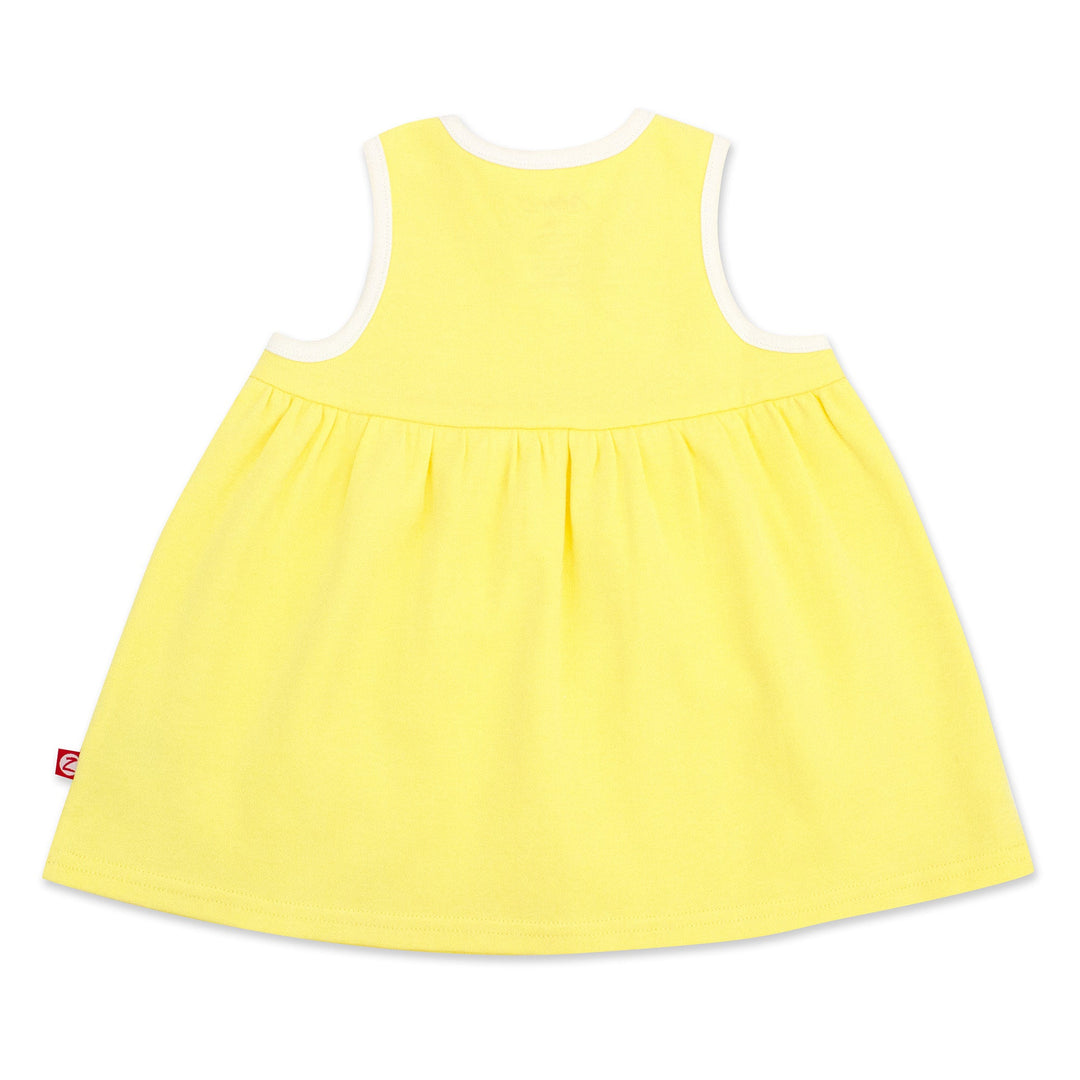 A sleeveless yellow sundress with faux wrap styling, made from organic cotton.