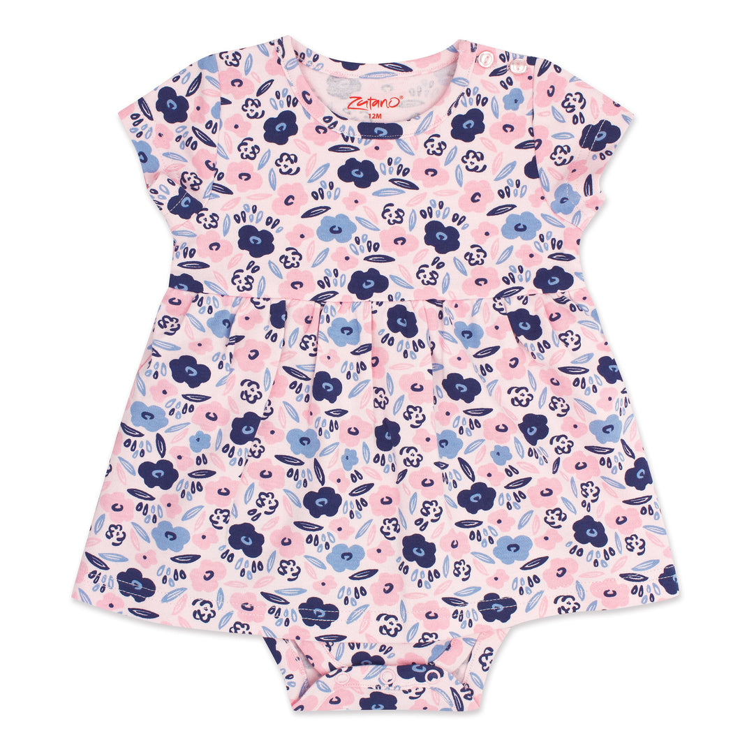 A short-sleeved romper dress for a baby girl with a blossoms print in pink, blue, and white colors, featuring snaps at the shoulder and a onesie bottom.