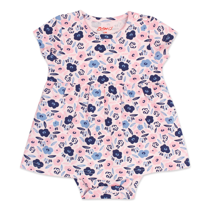 A short-sleeved romper dress for a baby girl with a blossoms print in pink, blue, and white colors, featuring snaps at the shoulder and a onesie bottom.