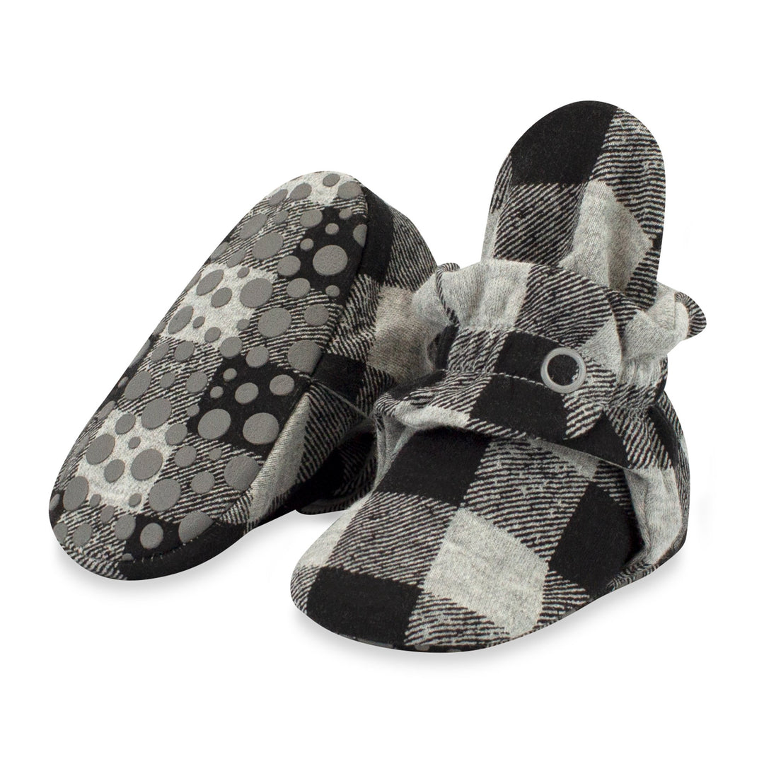 A pair of gray buffalo check organic cotton baby booties with gripper soles and a two-snap secure fit.
