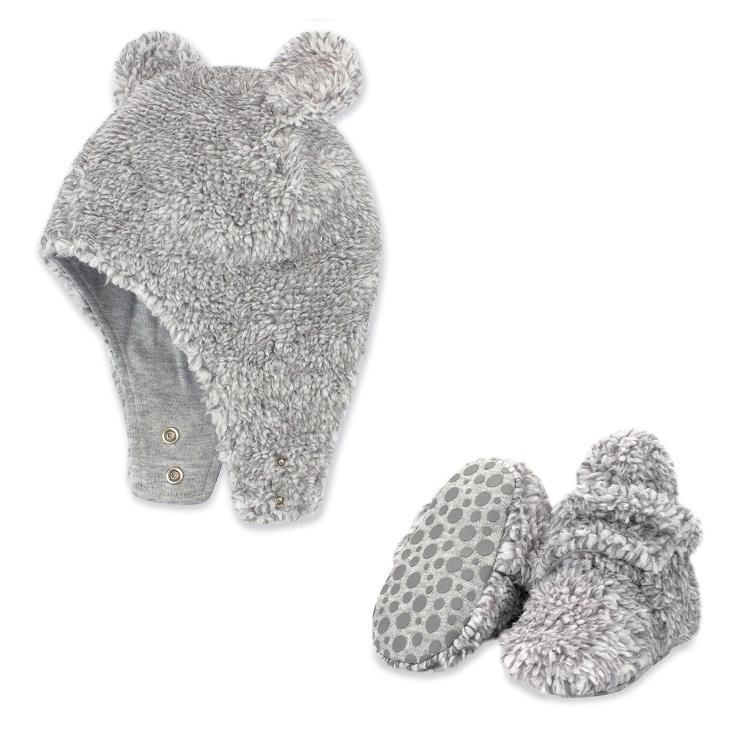 A set of heather gray faux fur baby booties and a matching hat with bear ears.