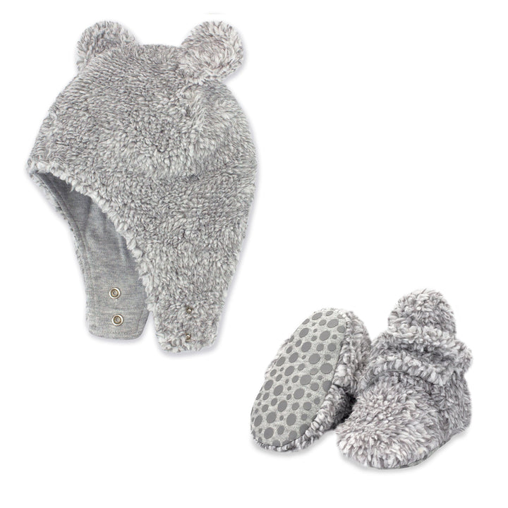 A set of heather gray faux fur baby booties and a matching hat with bear ears.