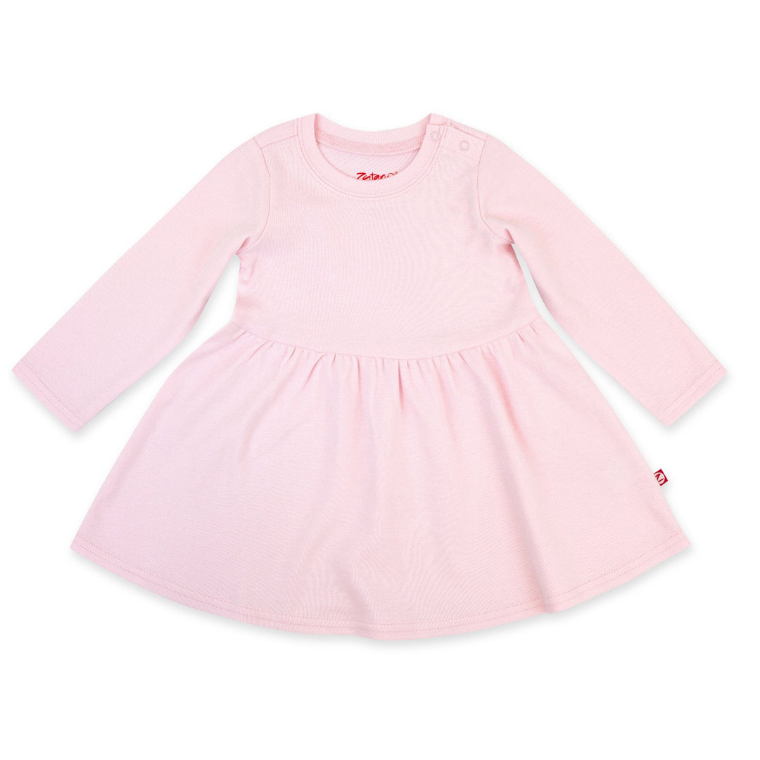 A long sleeve baby pink dress made of organic cotton, laid flat on a white background.