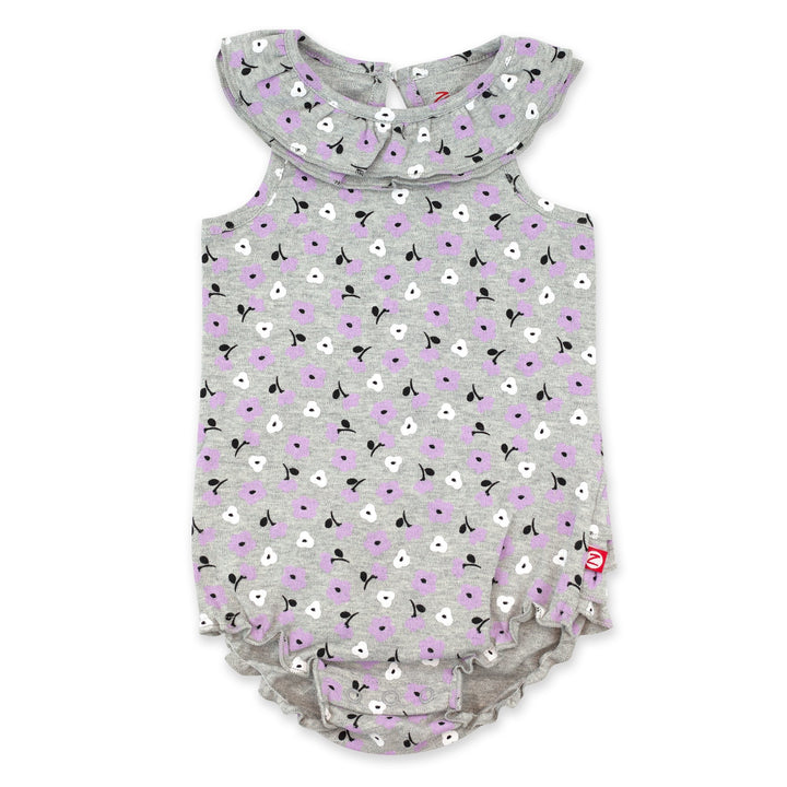 Organic cotton ruffle romper for baby girl with a Primrose print in heather gray, featuring a ruffled collar and bottom, keyhole opening at the back, and snaps between the legs.