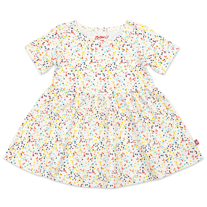 A short sleeve baby dress with a confetti print in various colors on a cream background.