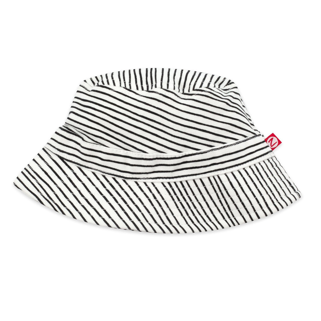 A black and white pencil striped organic cotton bucket hat with a red logo tag on the brim.