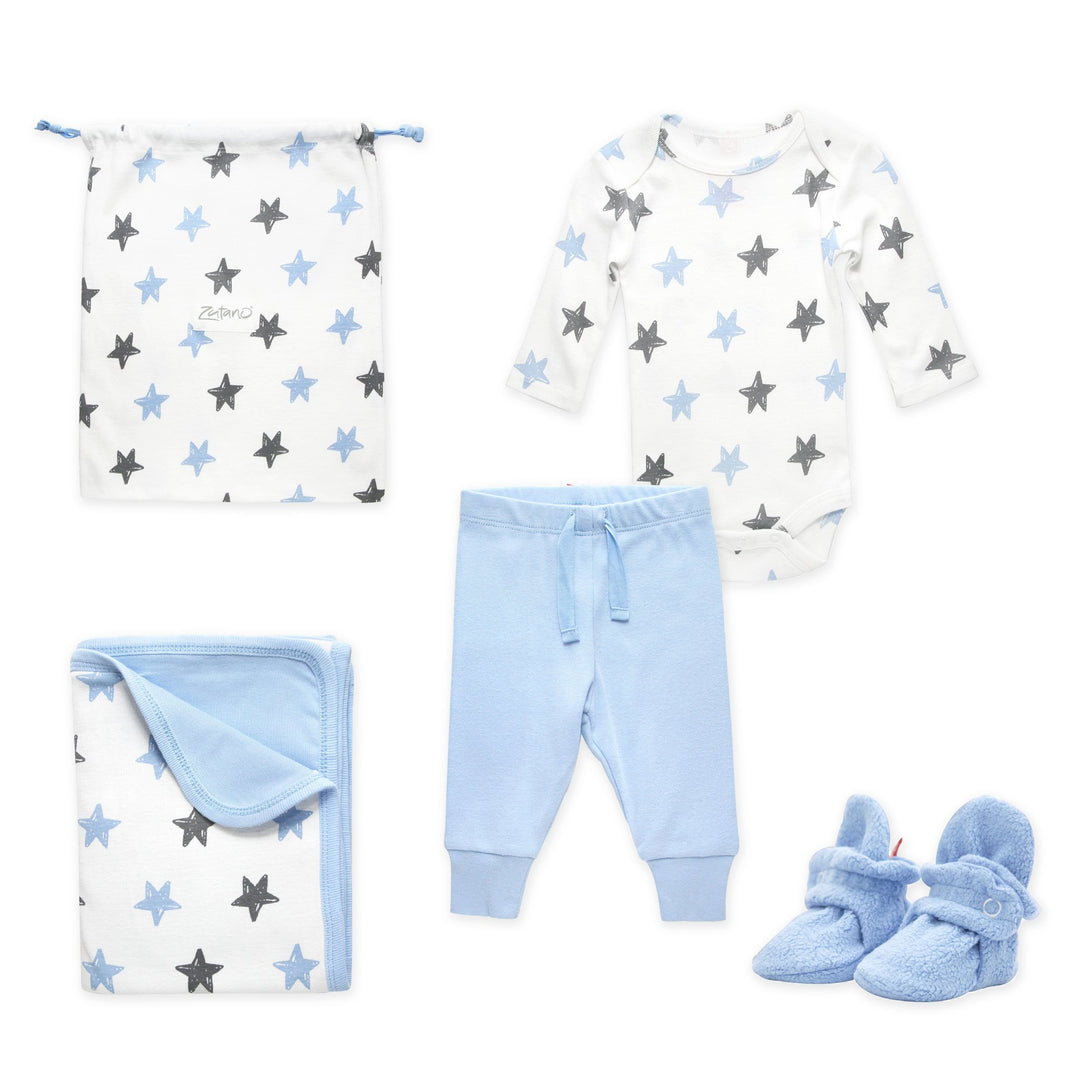 A 4 piece baby gift set including light blue cozie fleece booties, a long sleeve organic cotton bodysuit, organic cotton pants, and a blanket with a stars print, all packaged in a matching organic cotton drawstring bag.