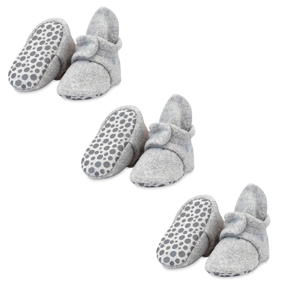 Three pairs of heather gray baby booties with gripper soles and decorative bow details.