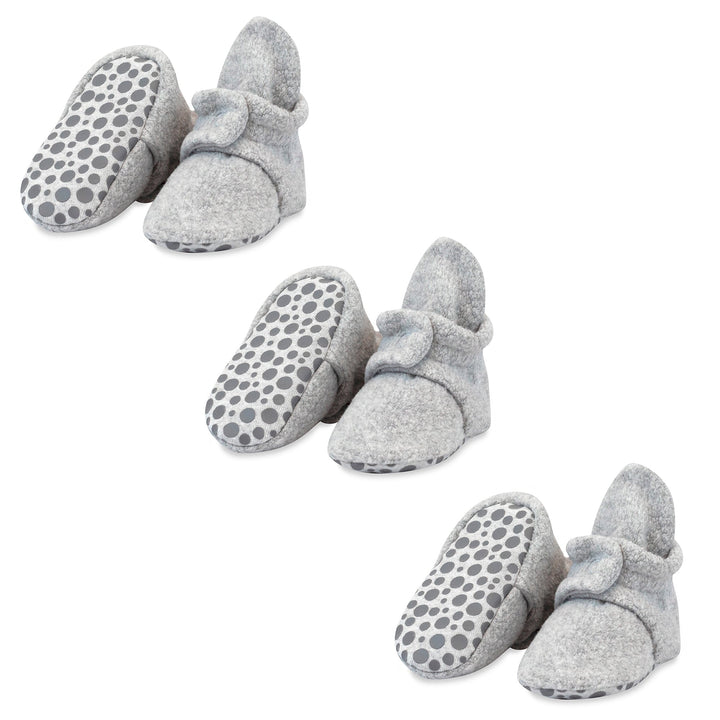 Three pairs of heather gray baby booties with gripper soles and decorative bow details.