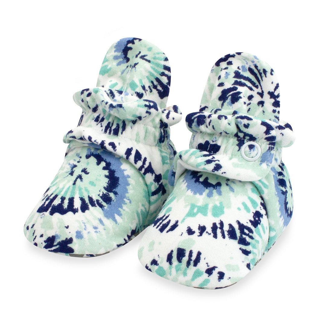 Organic cotton baby booties with a tie-dye pattern in shades of blue and white.