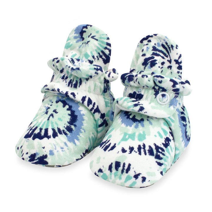 Organic cotton baby booties with a tie-dye pattern in shades of blue and white.
