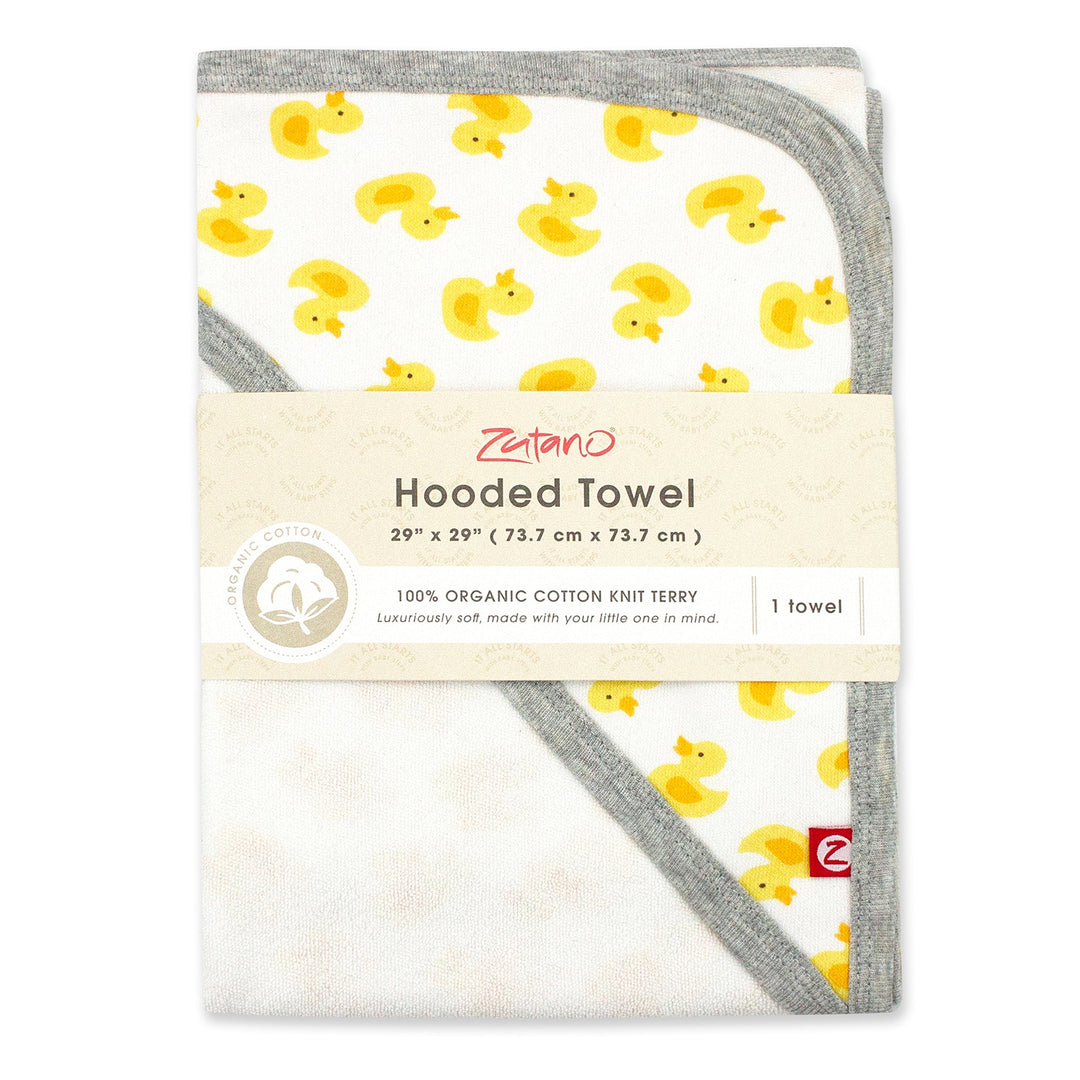 Packaged hooded towel with yellow ducks on white background with gray trim.