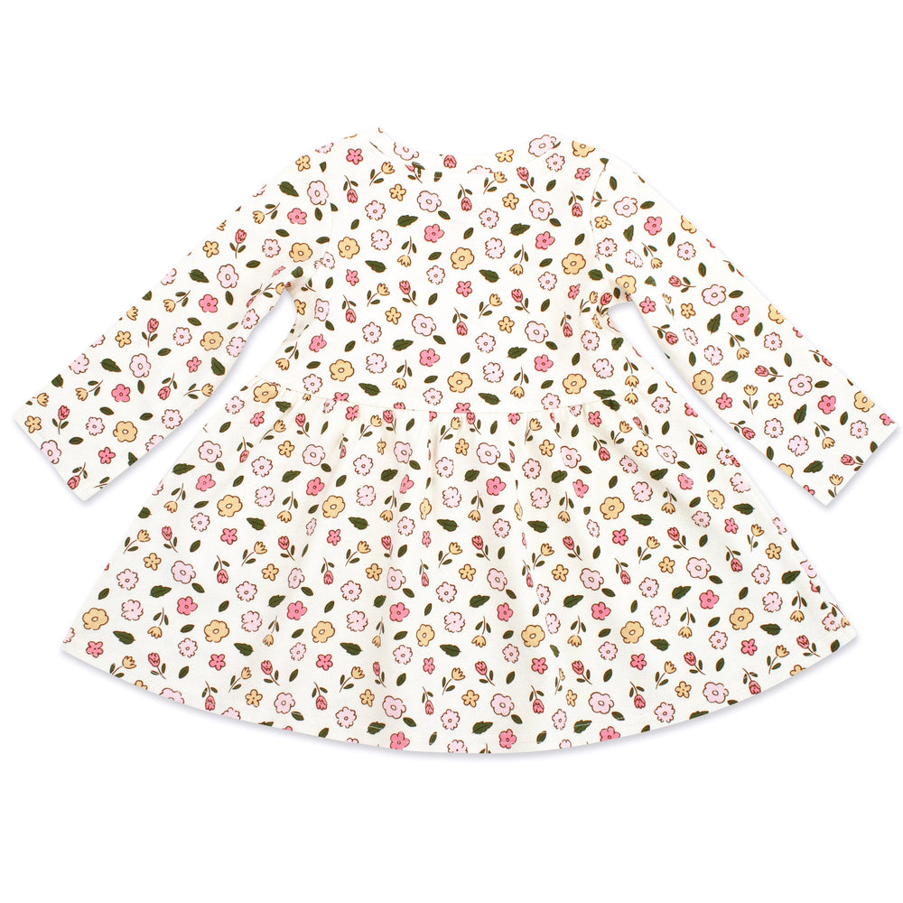 A long sleeve white organic cotton interlock dress for babies.