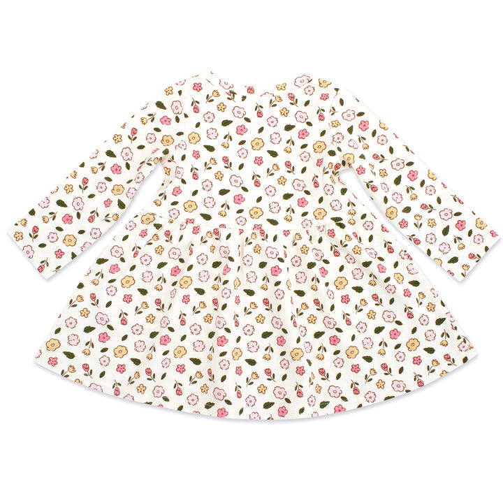 A long sleeve white organic cotton interlock dress for babies.