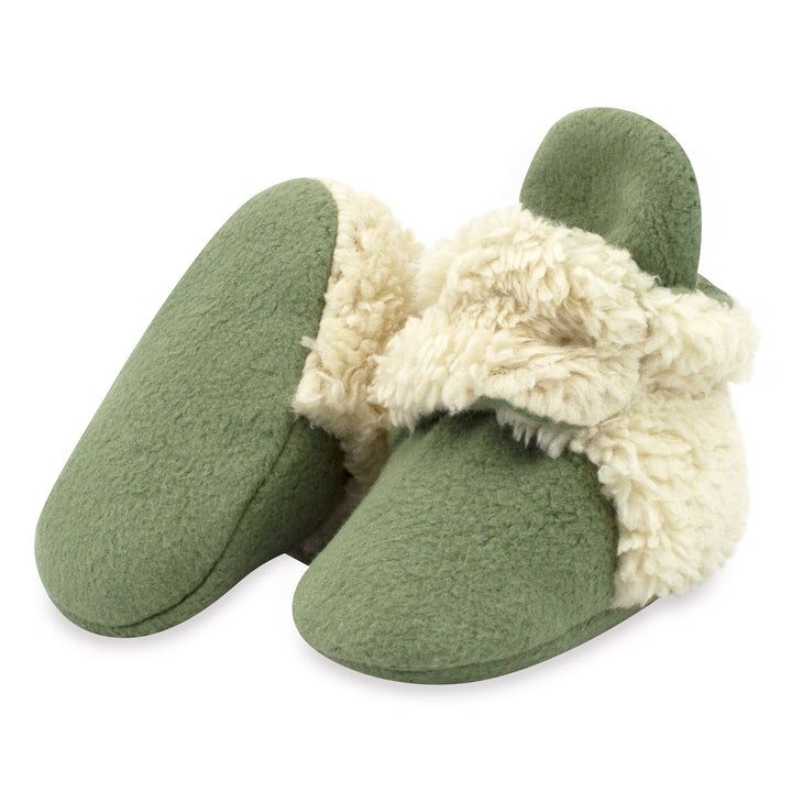 Olive green baby booties with furry white detailing on the heel and strap.