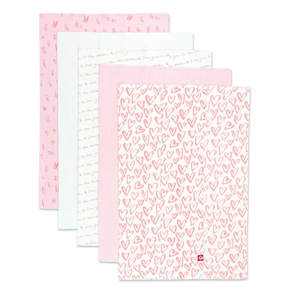 Packaged set of five organic cotton burp cloths with a pink and white heart print.
