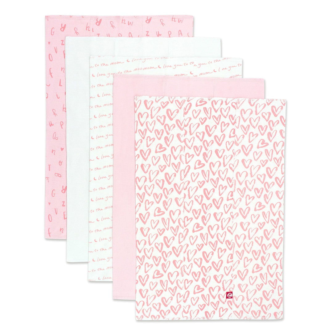 Packaged set of five organic cotton burp cloths with a pink and white heart print.