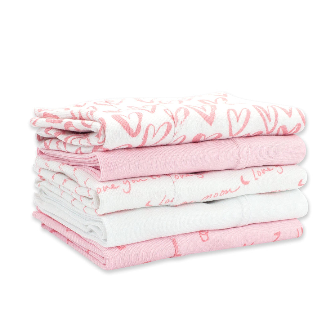 Set of five organic cotton burp cloths with a pink and white heart print.