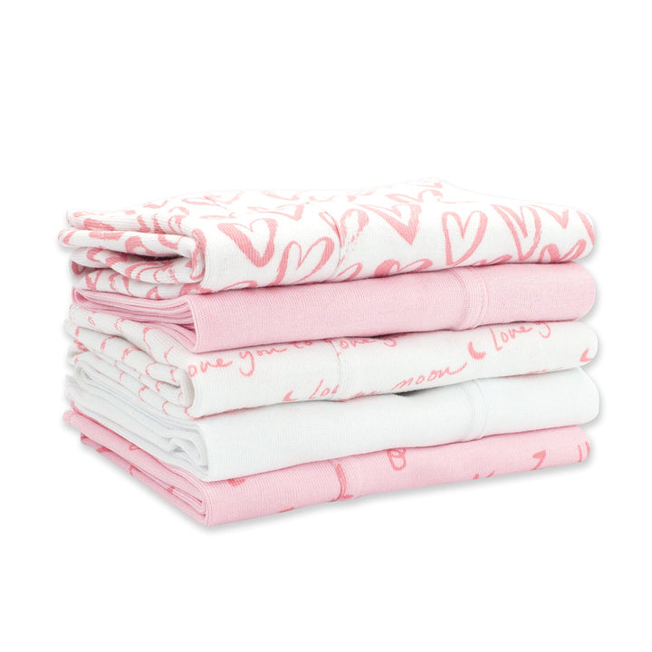 Set of five organic cotton burp cloths with a pink and white heart print.