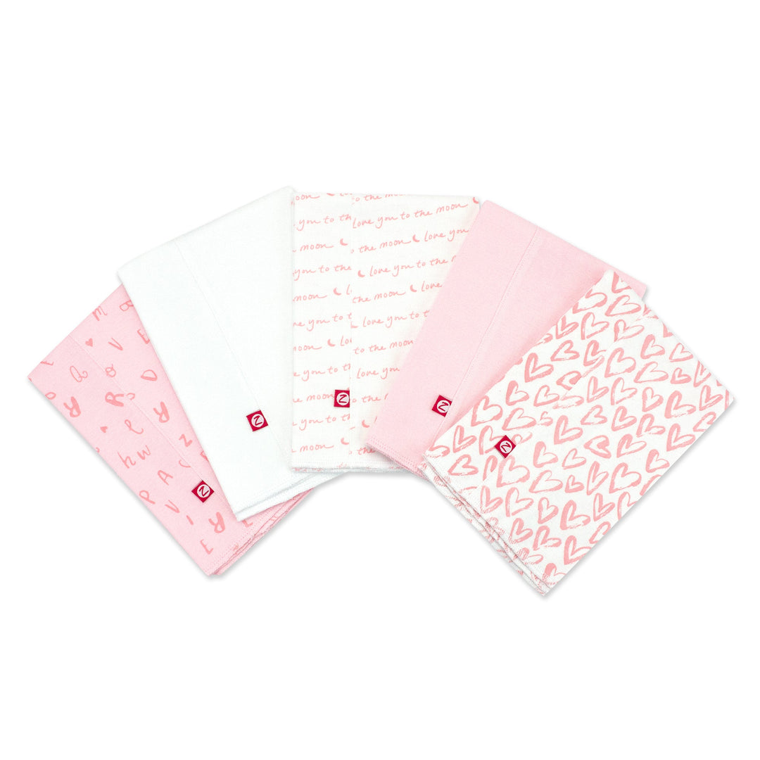 Set of five organic cotton burp cloths with a pink and white heart print.