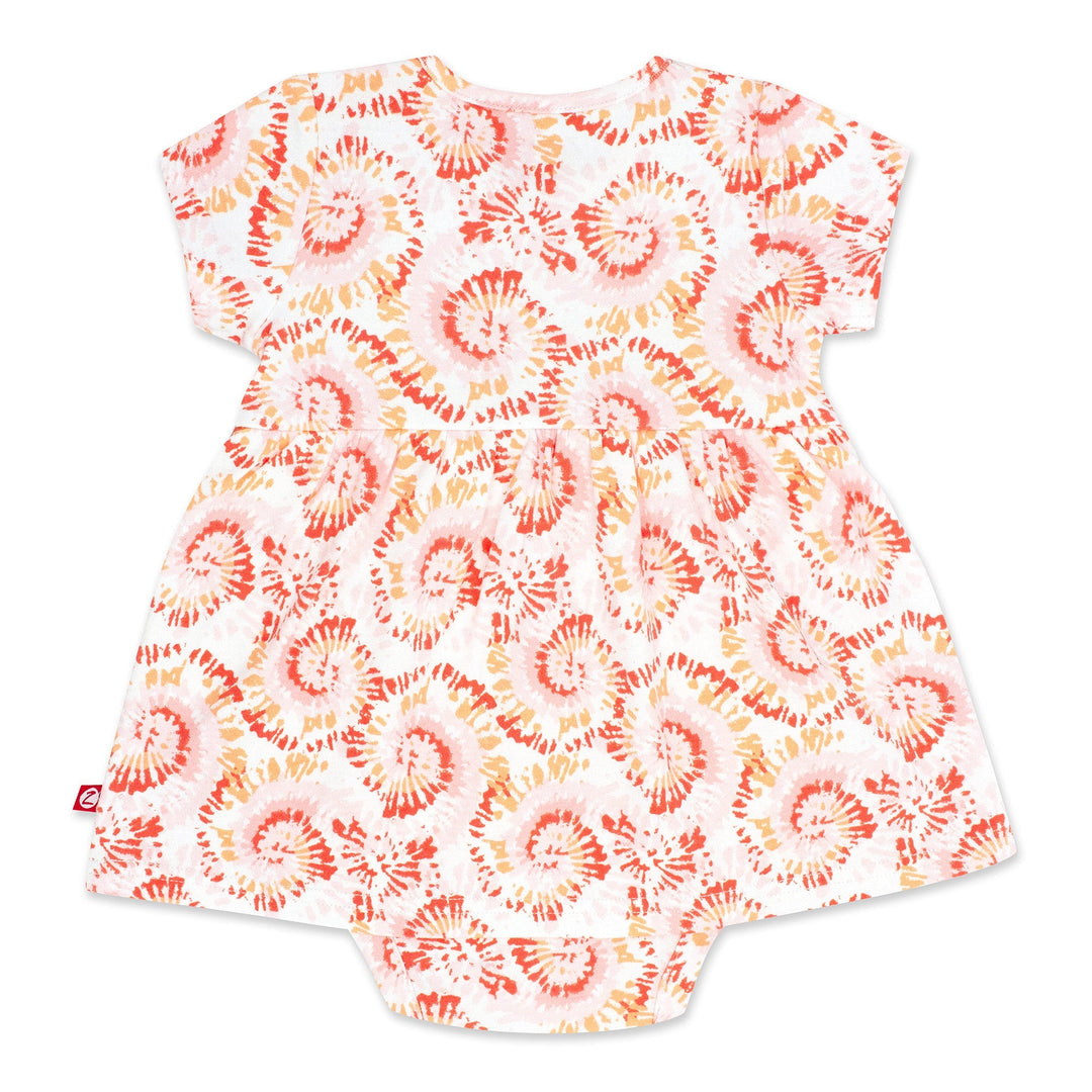 Short-sleeved tie-dye organic cotton romper dress for a baby girl, predominantly in a coral color.
