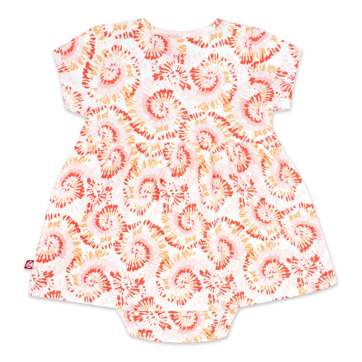 Short-sleeved tie-dye organic cotton romper dress for a baby girl, predominantly in a coral color.