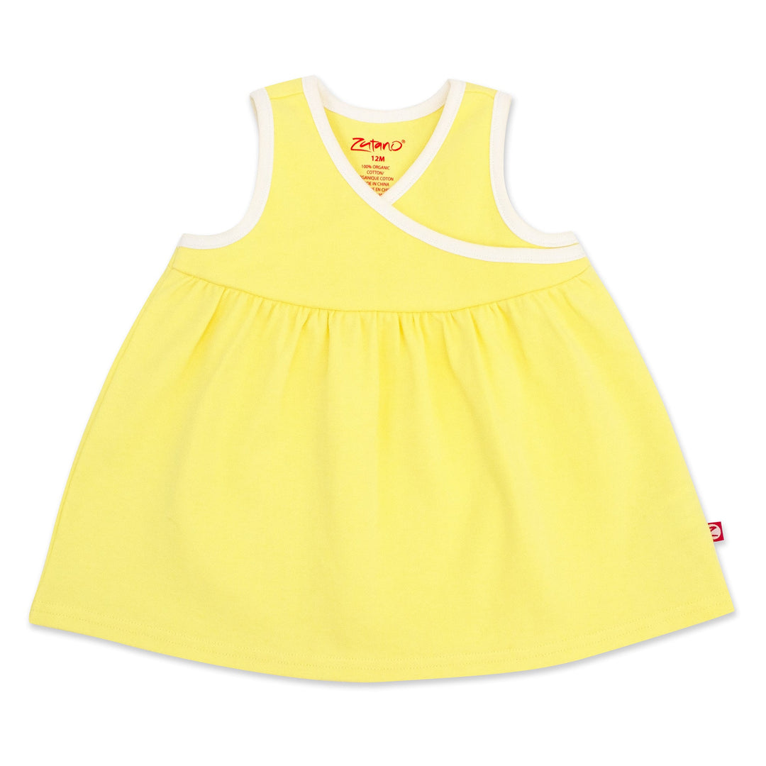 A sleeveless yellow sundress with faux wrap styling, made from organic cotton, displayed against a white background.