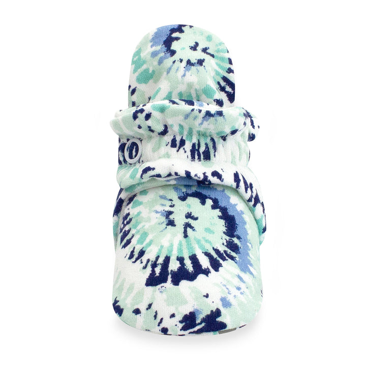 Organic cotton baby booties with a tie-dye pattern in shades of blue and white, featuring rubber grippers on the bottom.