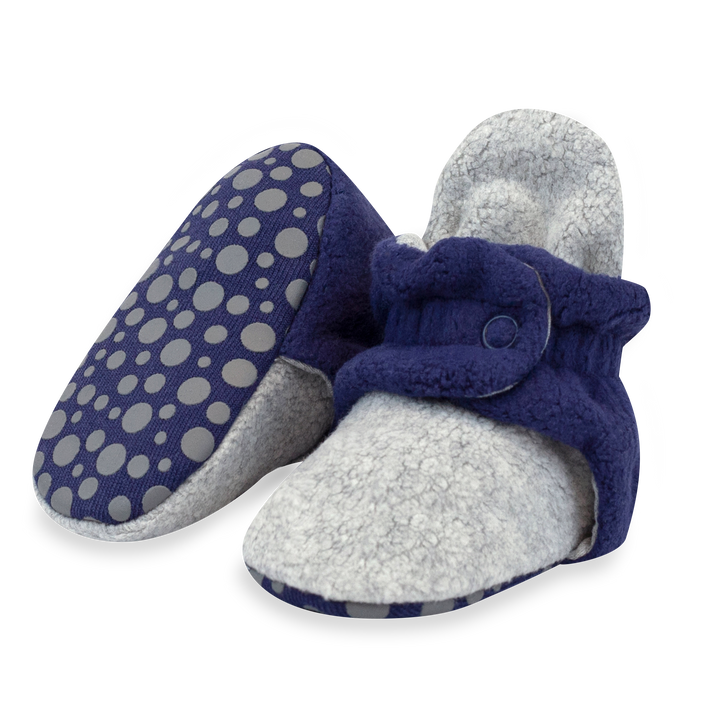 Baby booties in Heather Gray and True Navy color block with fleece exterior and visible snaps.