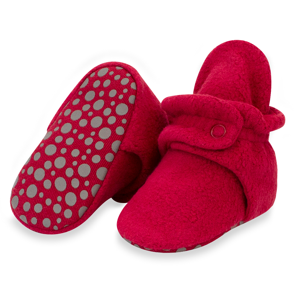 Set of cranberry red fleece baby booties with two-snap secure fit and non-slip gripper soles.