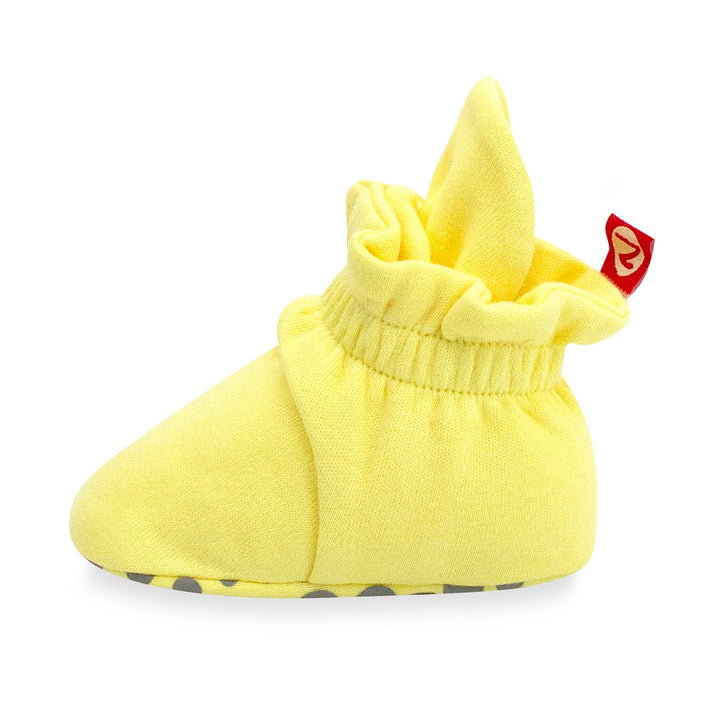 Yellow organic cotton baby booties with gripper soles and a popcorn print.