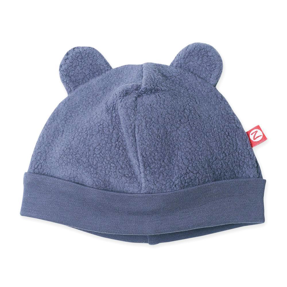 A denim navy colored fleece baby hat with ears resembling a bear's face.