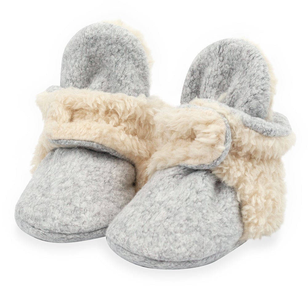 A pair of heather gray baby booties with furry detailing on the heel and strap.