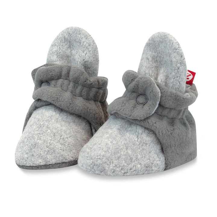 A pair of gray baby booties with color block design and two adjustable snaps.
