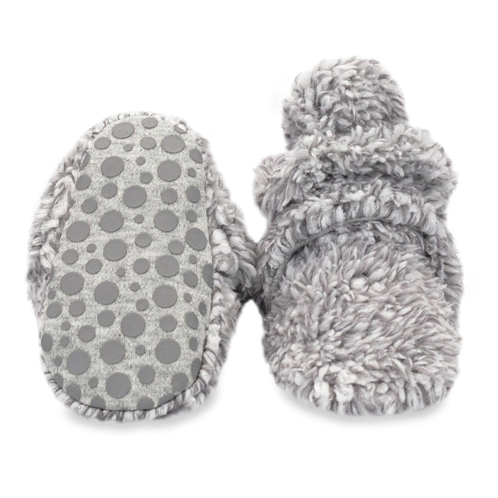 Baby booties with gripper dots on the bottom made from organic cotton.