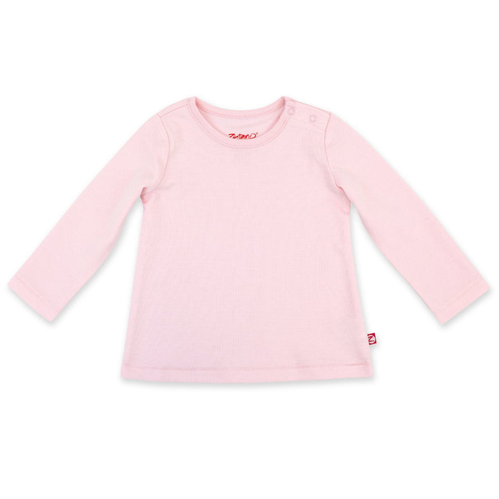 A long sleeve baby girl's shirt in baby pink color with a flared design, laid flat on a solid background.
