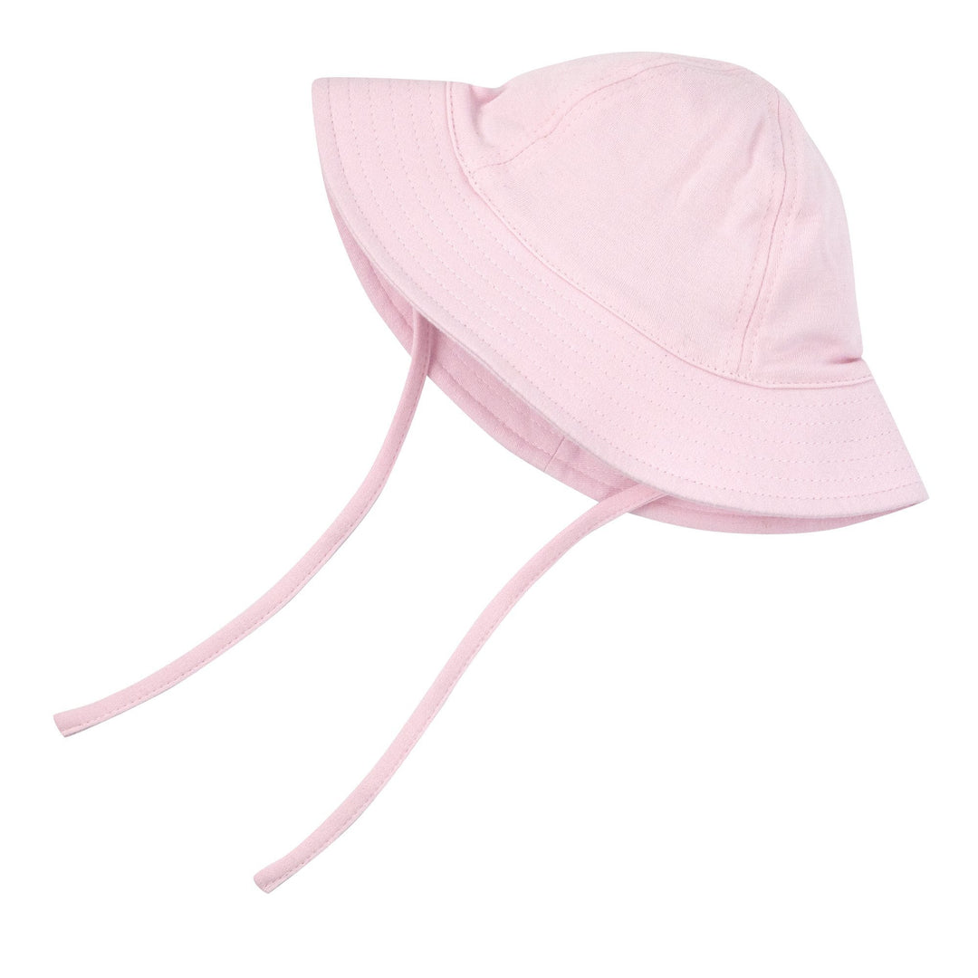 A baby pink sun hat with wide brim and chin ties made from organic cotton.