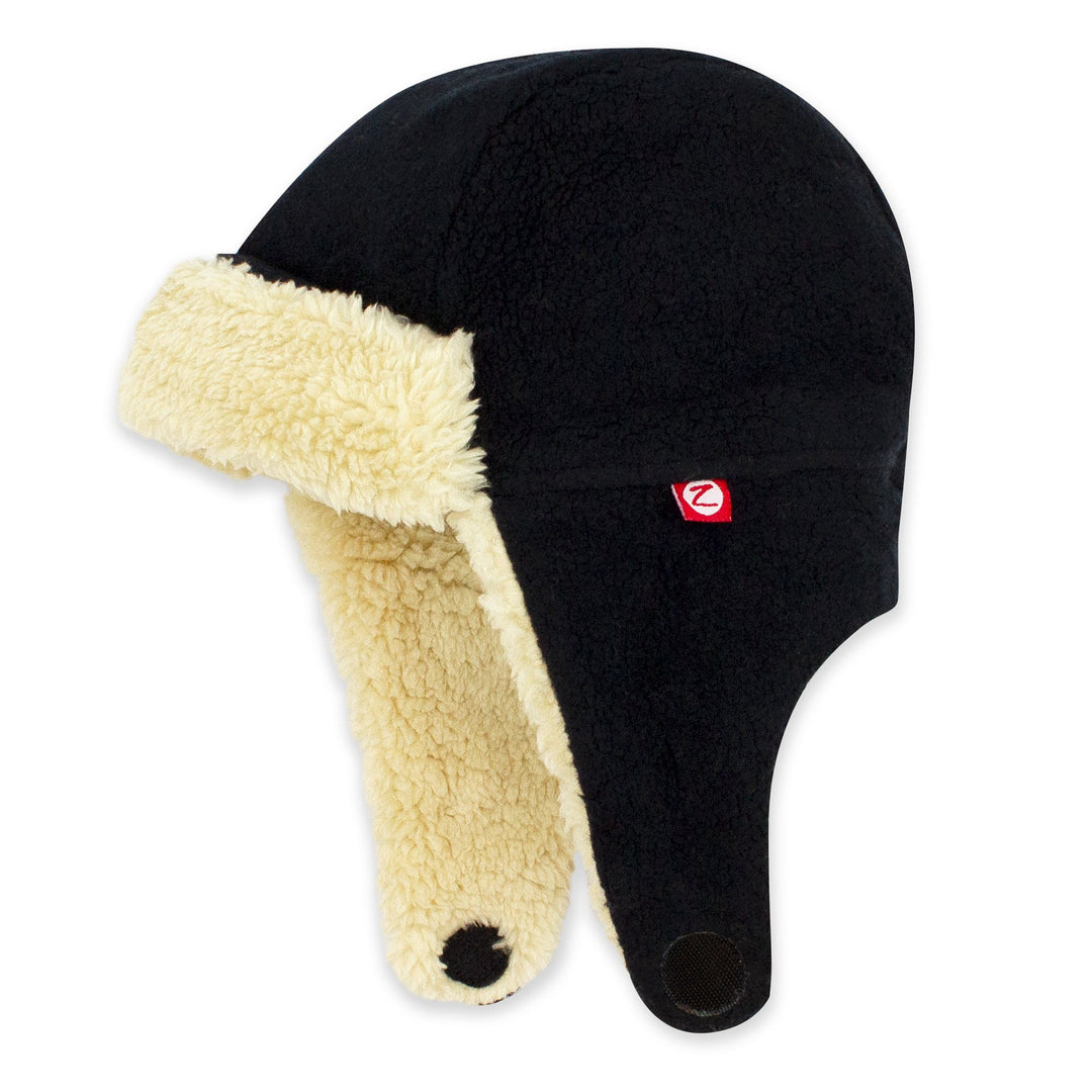 A black fleece trapper hat with a soft furry lining and straps velcroing under the chin, displayed on a white background.