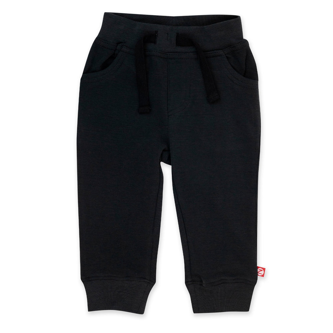 Black organic cotton baby jogger pants with pockets and an elastic waistband.