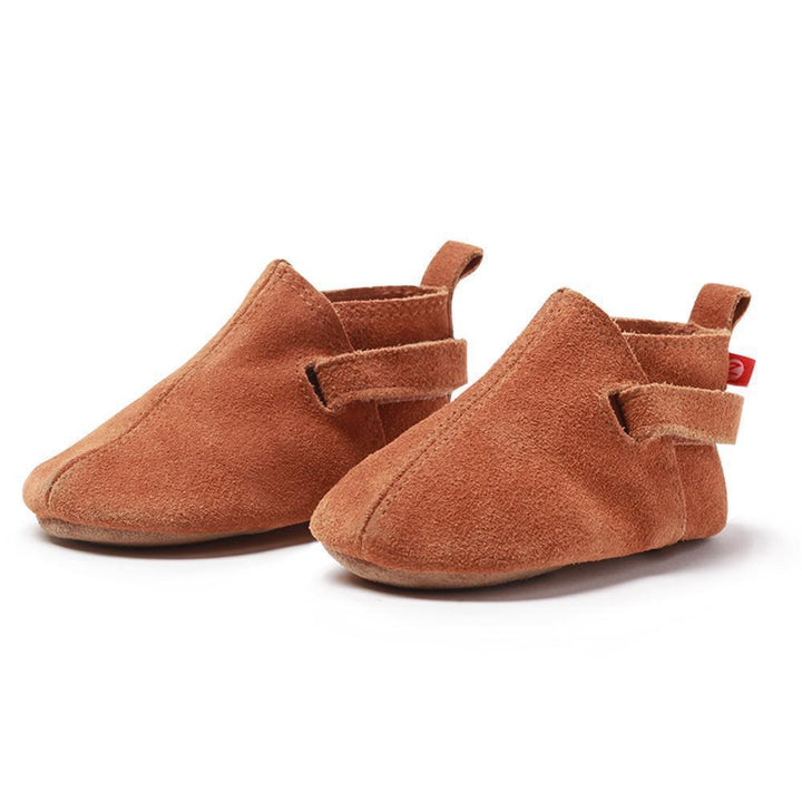 A pair of brown suede baby shoes with adjustable hook and loop straps.