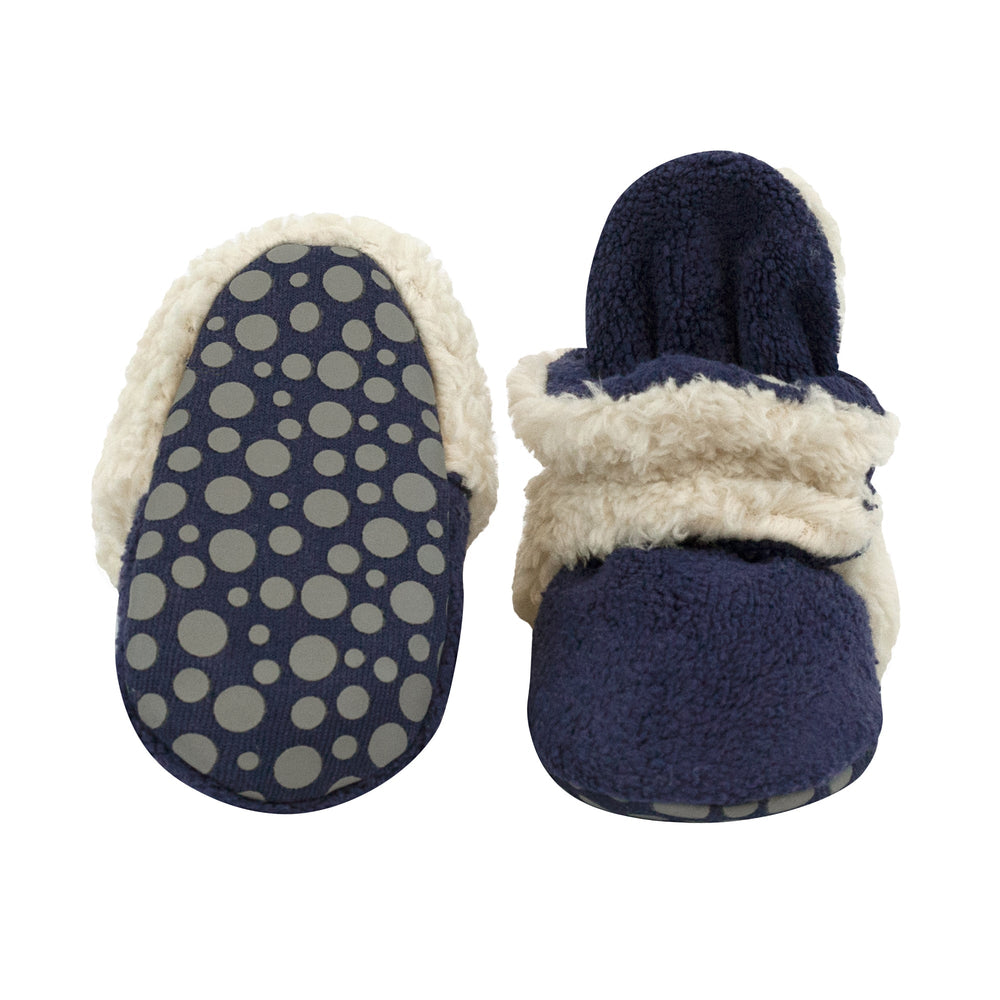 Our cozie furry booties feature our signature cozie fleece exterior with comfy furry fabric detailing on the heel and strap for added warmth and style.