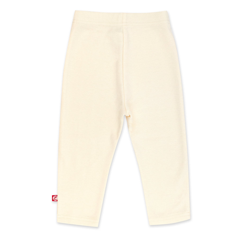 Cream-colored organic cotton leggings for babies, with a thick elastic waist band.