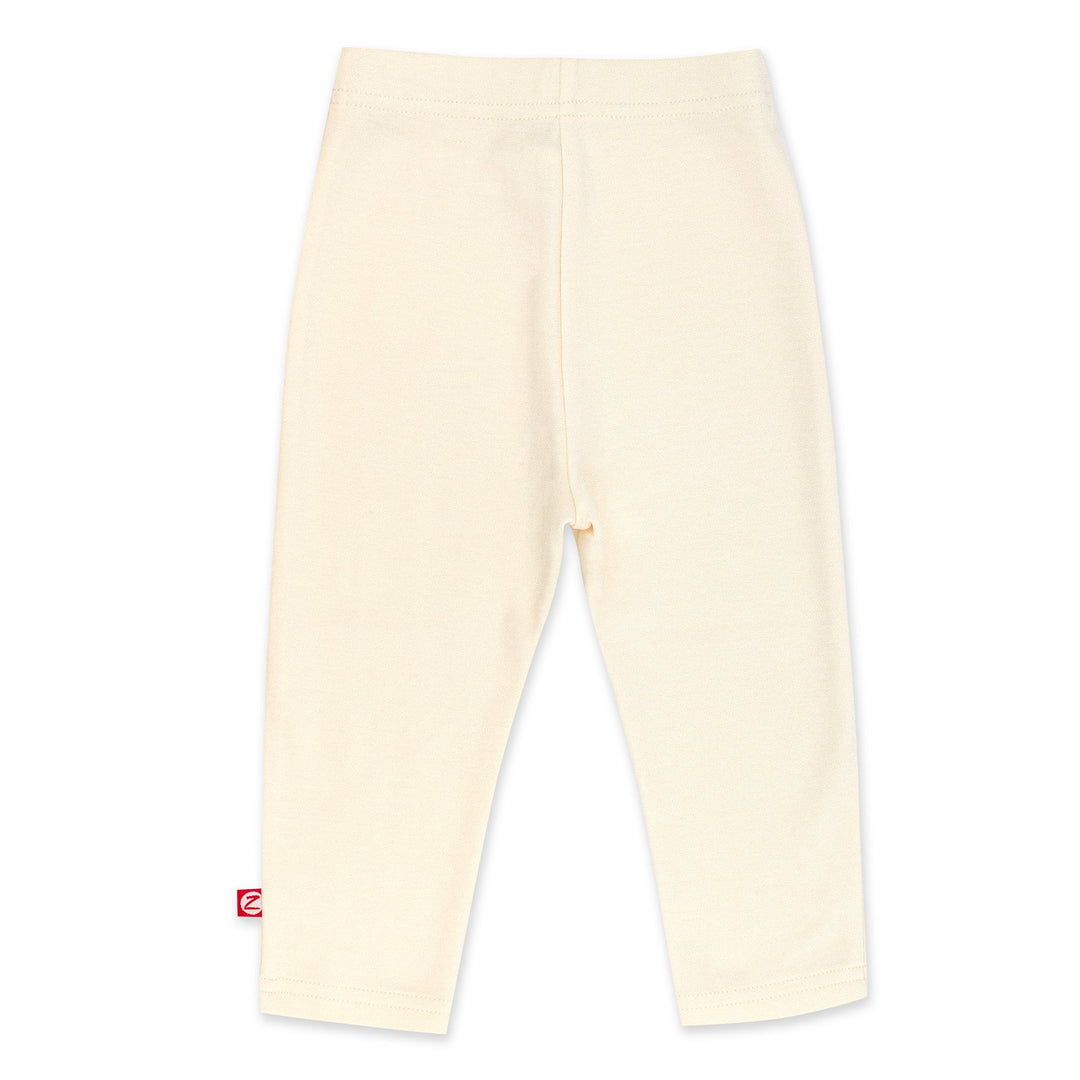 Cream-colored organic cotton leggings for babies, with a thick elastic waist band.