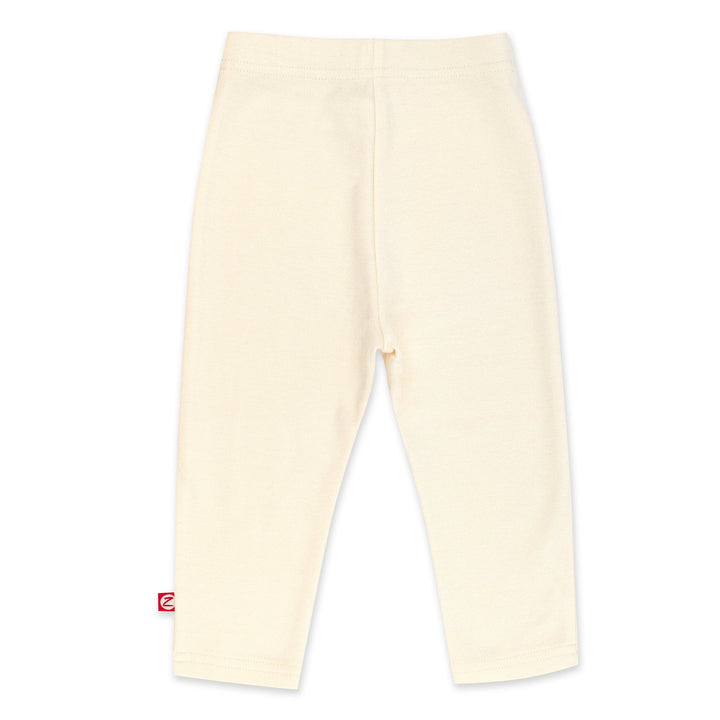 Cream-colored organic cotton leggings for babies, with a thick elastic waist band.