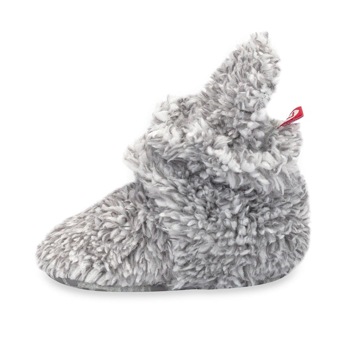 Faux fur baby booties with gripper dots on the bottom.