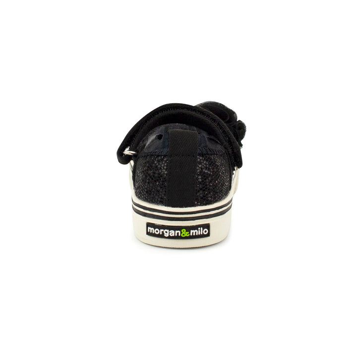 Hook & loop strap Mary Jane black shoe with a touch of added personality.