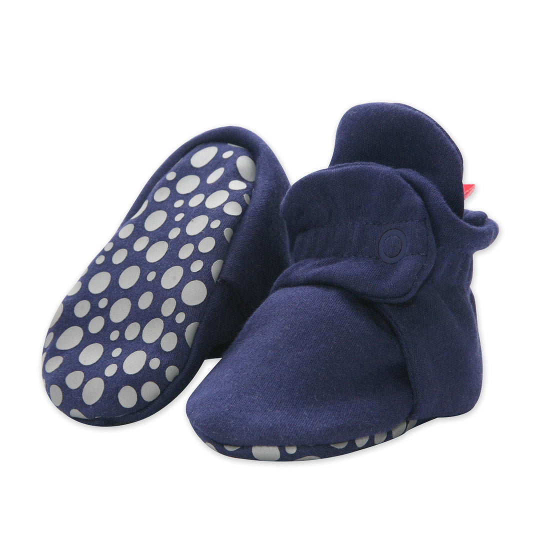 A pair of navy blue organic cotton baby booties with gripper soles.